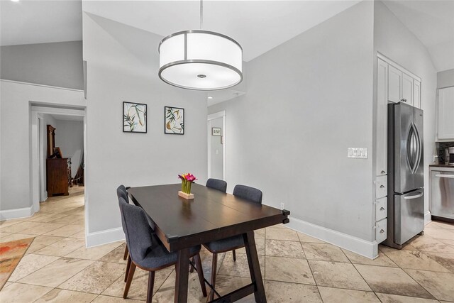 dining area featuring vaulted ceiling