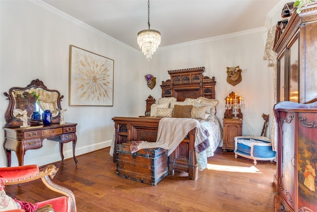 bedroom featuring dark hardwood / wood-style flooring, crown molding, and an inviting chandelier