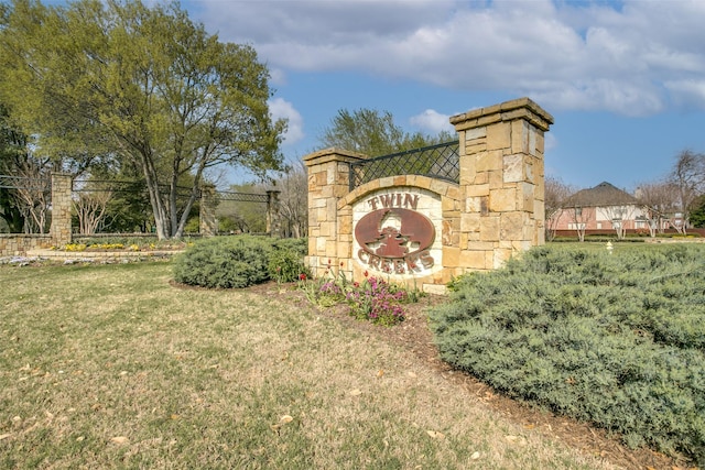 community sign featuring a lawn