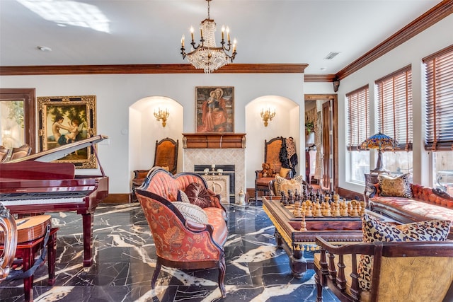 living room with a chandelier, ornamental molding, and a tiled fireplace