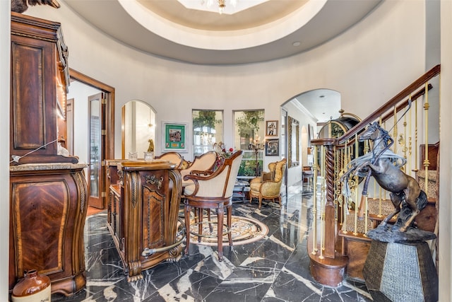 interior space featuring a high ceiling and a tray ceiling