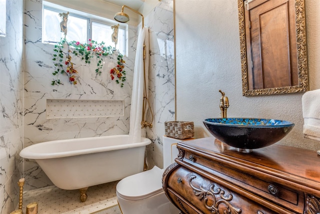 bathroom featuring a tub to relax in, toilet, and vanity