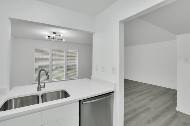 kitchen featuring dishwasher, white cabinetry, a chandelier, sink, and light hardwood / wood-style flooring