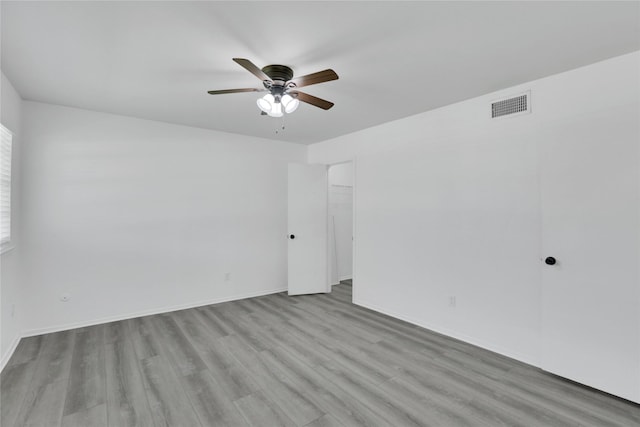 spare room featuring light wood-type flooring and ceiling fan