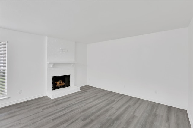 unfurnished living room with a fireplace and hardwood / wood-style floors