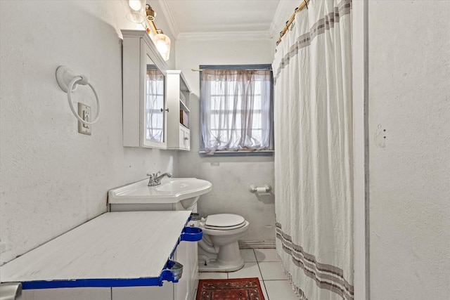 bathroom with crown molding, tile patterned floors, toilet, and sink