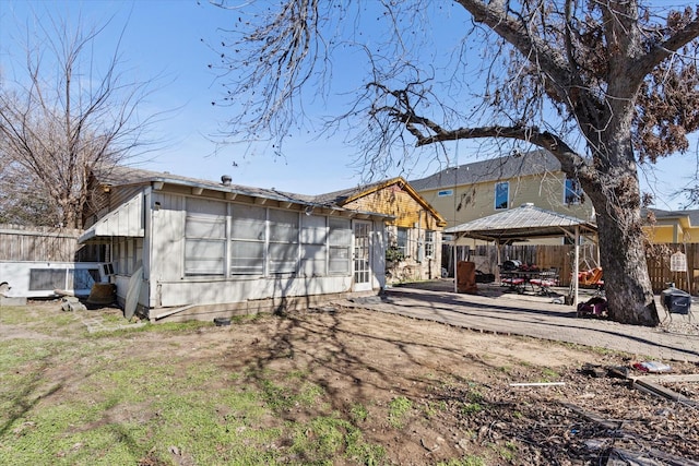 rear view of house featuring a gazebo and a patio area