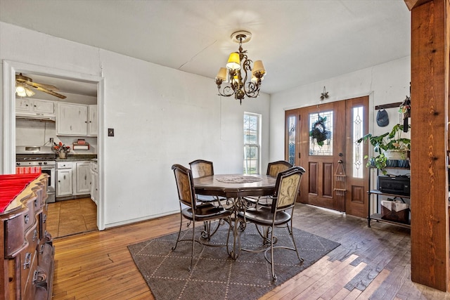 dining area featuring a notable chandelier and dark hardwood / wood-style flooring