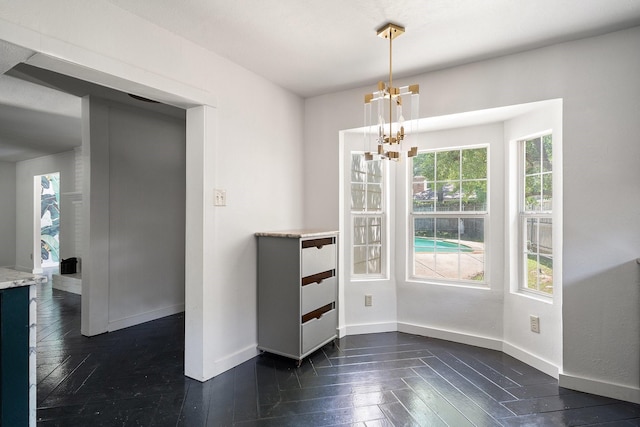 unfurnished dining area featuring a chandelier