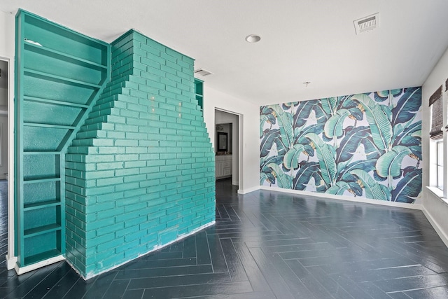 unfurnished living room with dark parquet flooring