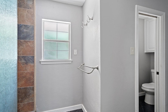 bathroom featuring toilet and tile patterned floors