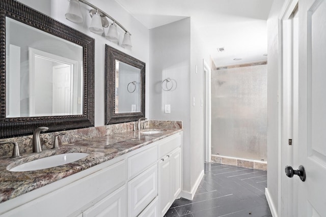 bathroom with tile patterned floors, walk in shower, and vanity