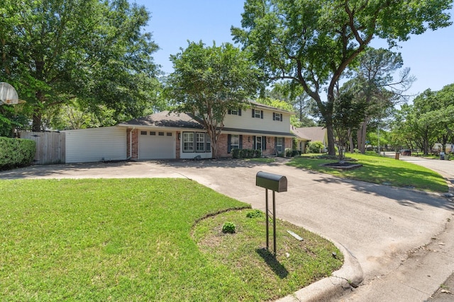 view of front of house featuring a front lawn and a garage