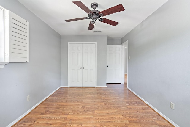 unfurnished bedroom with a closet, ceiling fan, and light wood-type flooring