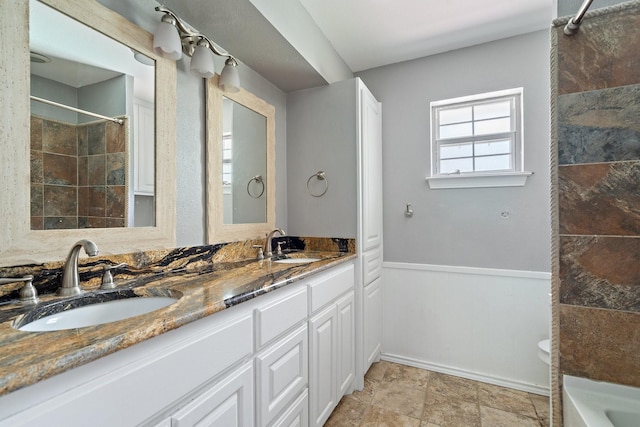 bathroom featuring walk in shower and vanity