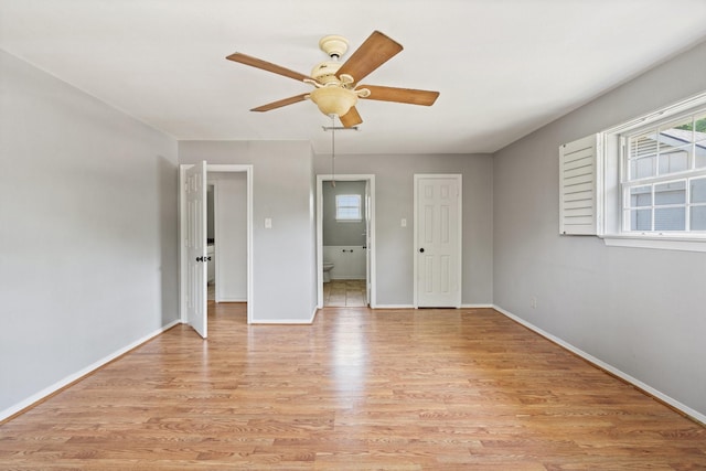 unfurnished bedroom featuring ensuite bathroom, a closet, ceiling fan, and light hardwood / wood-style floors