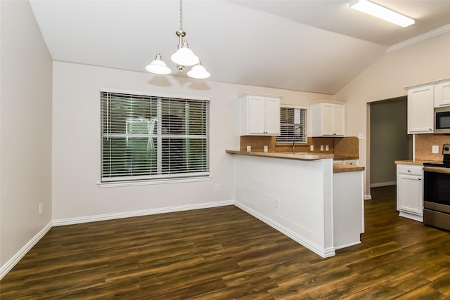 kitchen with appliances with stainless steel finishes, white cabinetry, kitchen peninsula, and tasteful backsplash