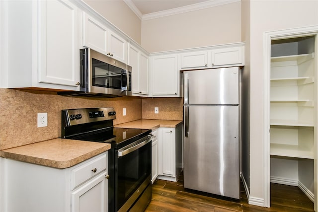 kitchen featuring stainless steel appliances, ornamental molding, dark hardwood / wood-style flooring, decorative backsplash, and white cabinets