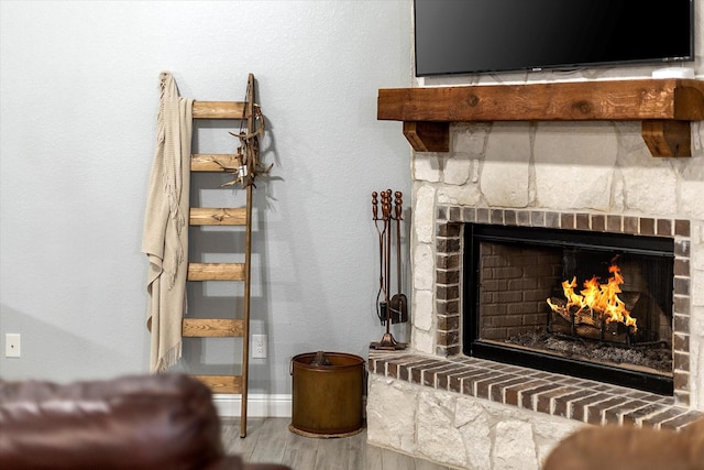 room details featuring a brick fireplace and hardwood / wood-style flooring