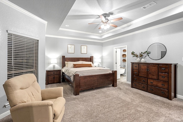 bedroom featuring ceiling fan, ornamental molding, light carpet, and a tray ceiling