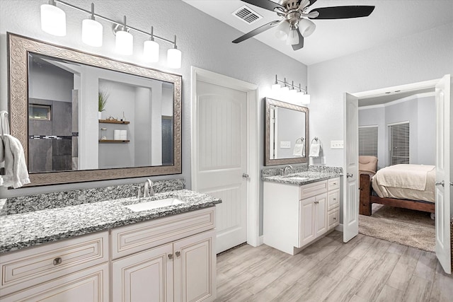 bathroom featuring hardwood / wood-style flooring, ceiling fan, and vanity