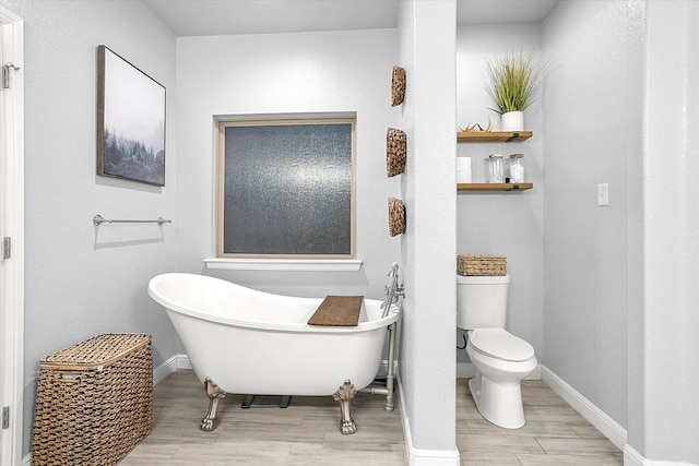 bathroom featuring a tub and toilet