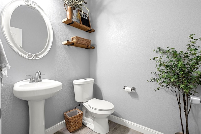 bathroom featuring sink, hardwood / wood-style floors, and toilet