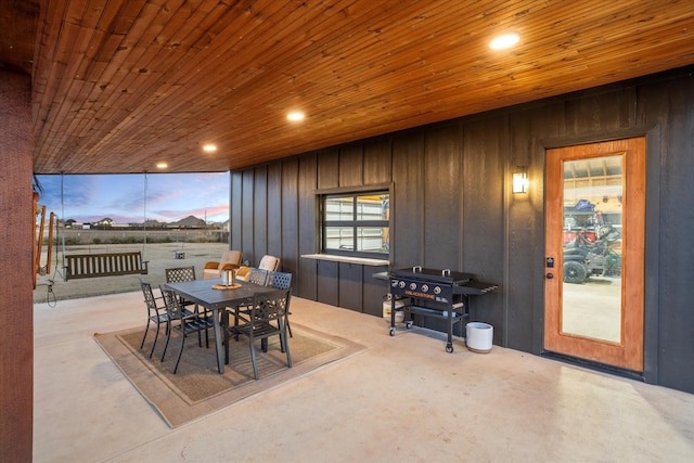 dining area featuring wood ceiling and wooden walls