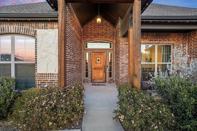 view of exterior entry at dusk