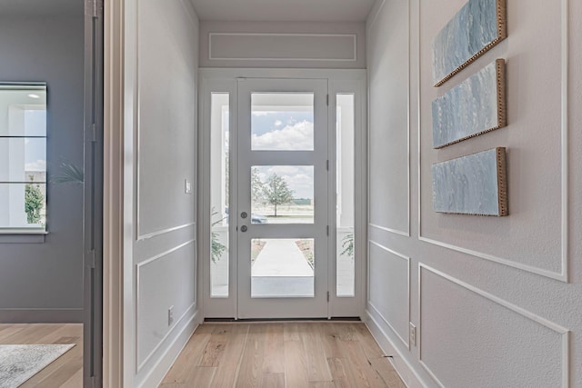 doorway featuring light wood-type flooring and plenty of natural light