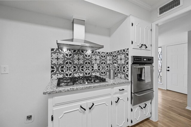 kitchen with white cabinets, dishwasher, light stone counters, sink, and backsplash