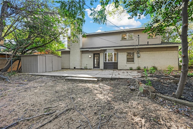 back of property with a patio and a shed