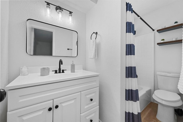 full bathroom featuring wood-type flooring, shower / tub combo, vanity, and toilet