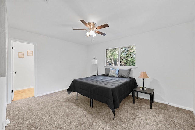 bedroom featuring ceiling fan and carpet