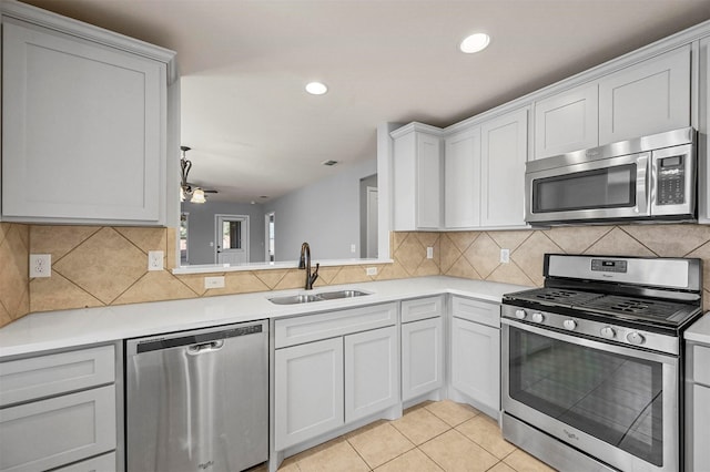 kitchen featuring sink, stainless steel appliances, and white cabinetry