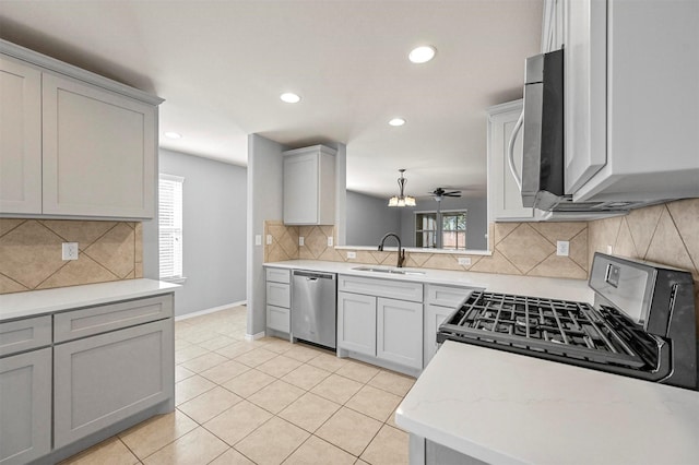 kitchen featuring stainless steel appliances, sink, ceiling fan, light tile patterned floors, and gray cabinets