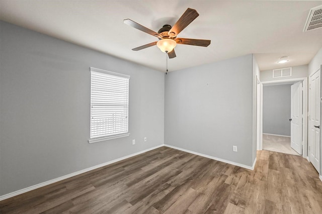 empty room featuring wood-type flooring and ceiling fan