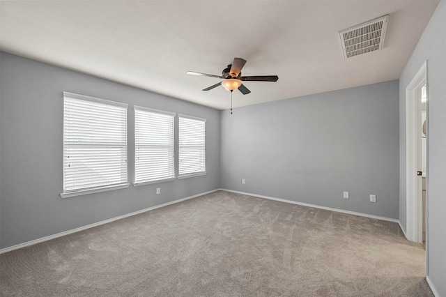 unfurnished room featuring light carpet and ceiling fan