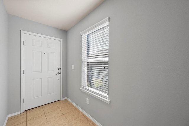 doorway with light tile patterned floors