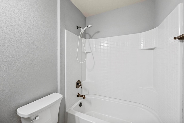 bathroom with toilet and bathing tub / shower combination