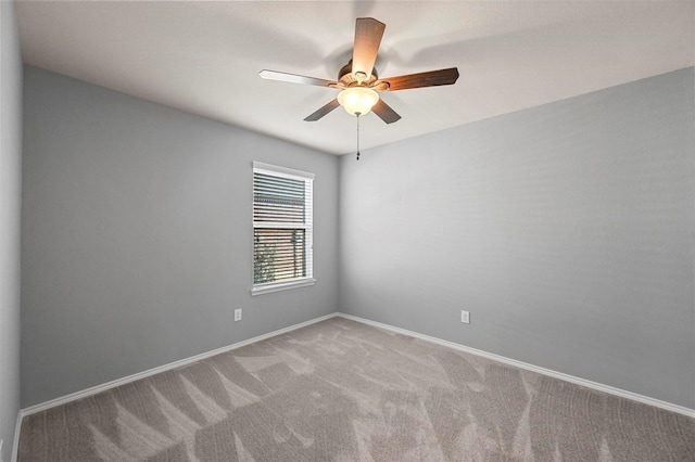 empty room featuring carpet floors and ceiling fan