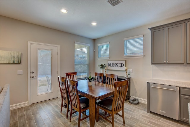 dining area with wood tiled floor, baseboards, visible vents, and recessed lighting