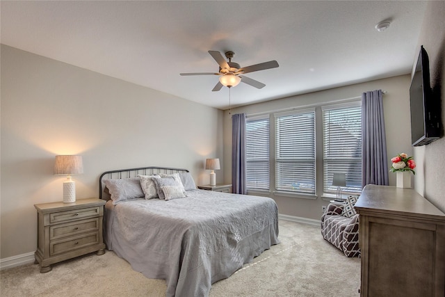 bedroom with baseboards, a ceiling fan, and light colored carpet