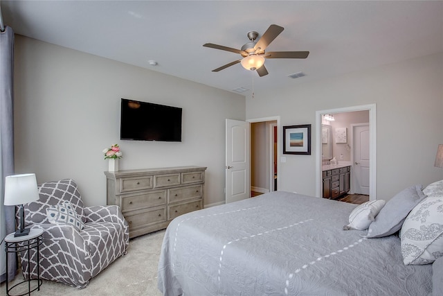 bedroom featuring light colored carpet, ceiling fan, visible vents, and connected bathroom