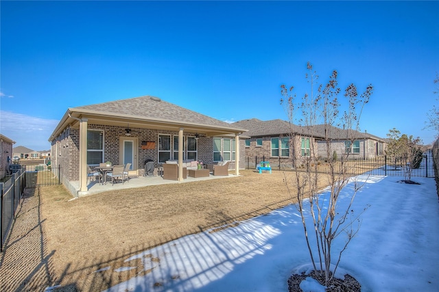 back of house featuring ceiling fan, an outdoor living space, and a patio