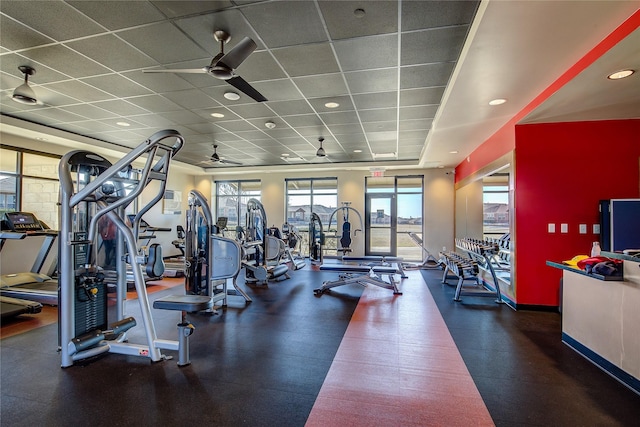 gym featuring ceiling fan and a drop ceiling