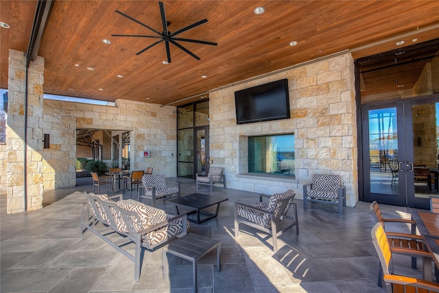 view of patio / terrace featuring ceiling fan and french doors