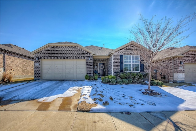 single story home featuring brick siding, roof with shingles, a garage, and concrete driveway