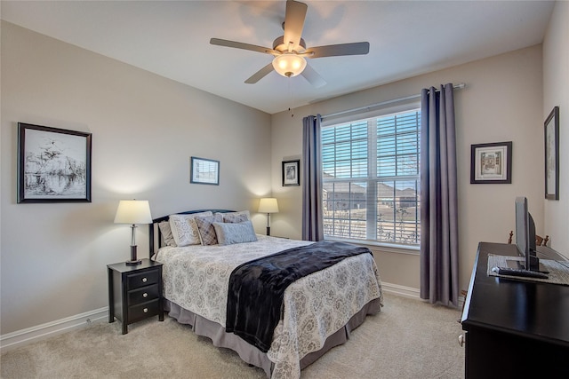 bedroom with light colored carpet, baseboards, and a ceiling fan