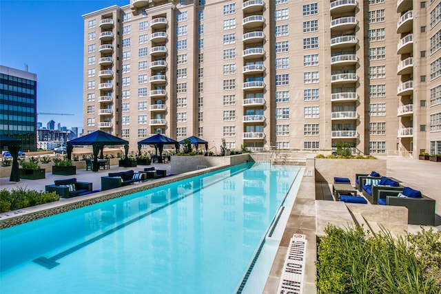 view of swimming pool featuring a patio area and a gazebo